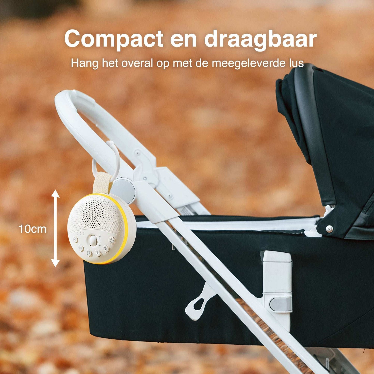 Portable baby stroller with a small white noise machine attached outdoors