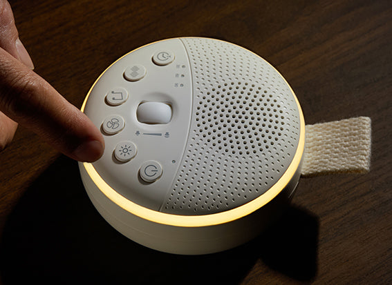 White swiftvein nimbus device with control buttons on a wooden surface
