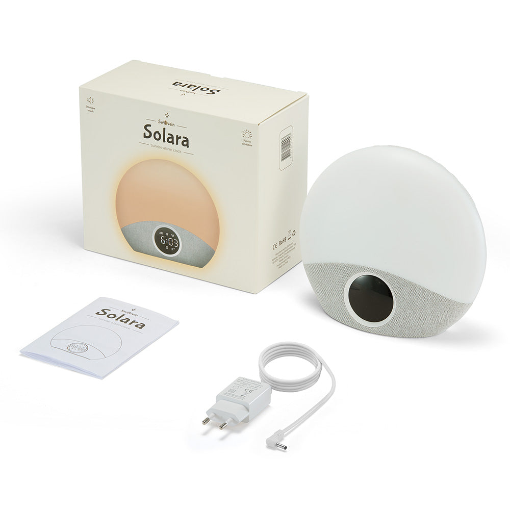 White Solara product with packaging, power cord, and user manual on a white background