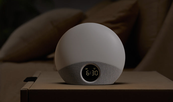 White spherical device with digital display on a wooden surface, blurred brown background